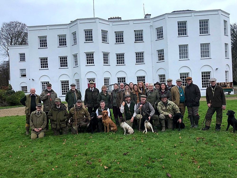 A shoot day group with their dogs, in front of Vaynol Hall