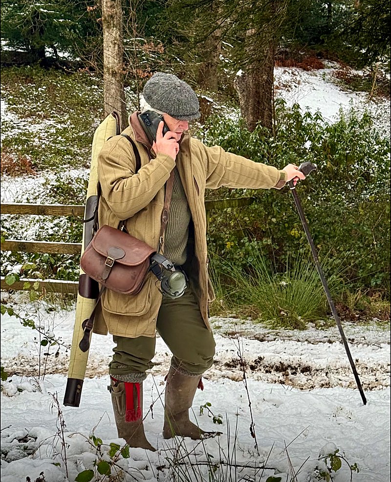 A shooter walking through snowy woods